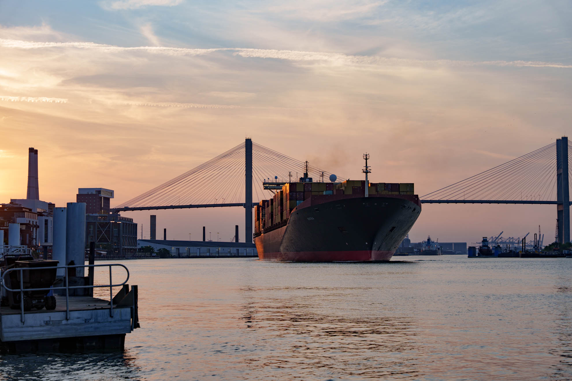 Container ship passing under the Talmadge Bridge at sunset, Savannah