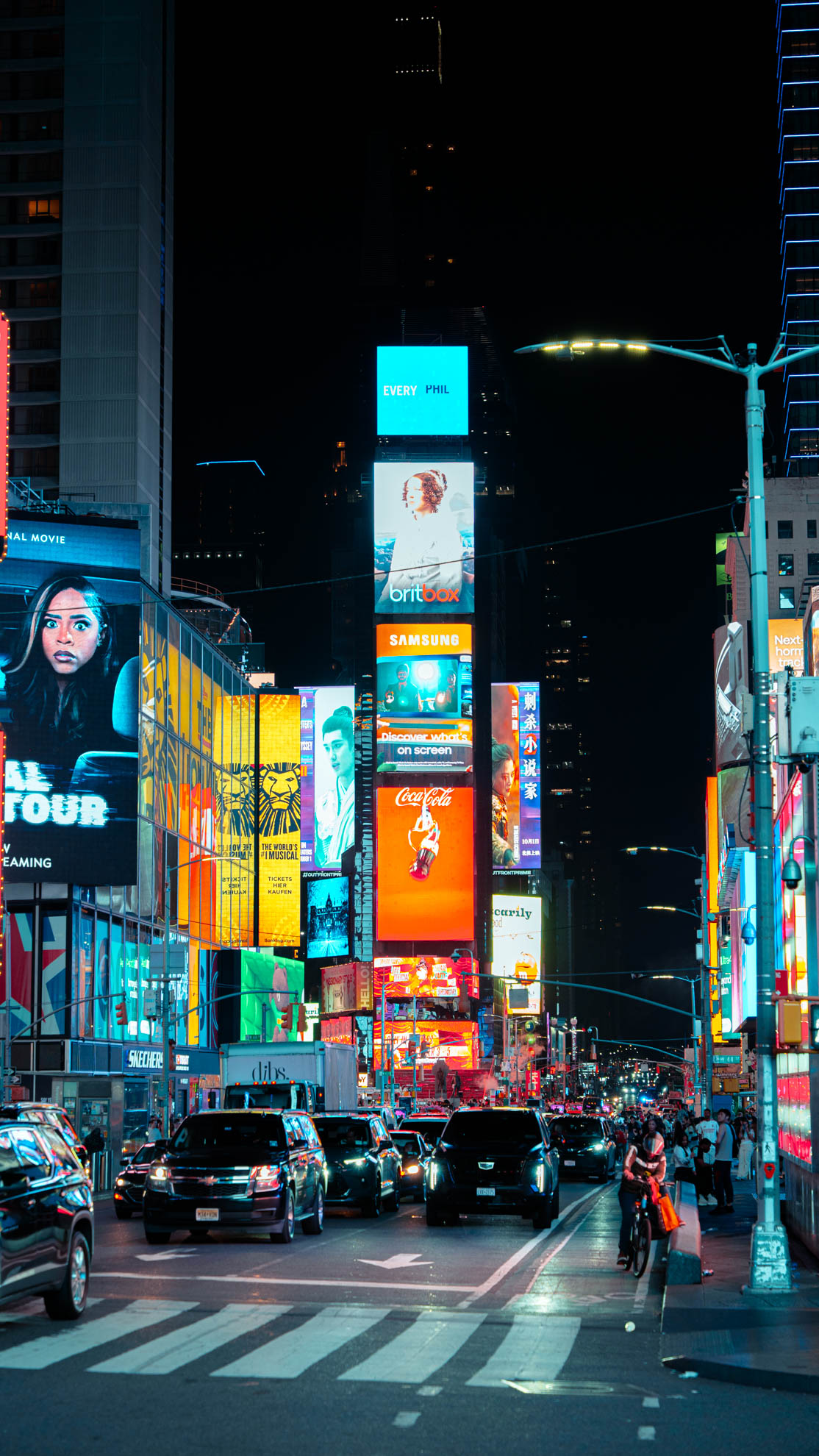 Times Square at night, neon signs and traffic